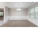 Dining room with neutral carpet, wainscoting detail, chandelier, and natural light from a large window at 3732 Landgraf Cv, Decatur, GA 30034