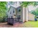 Charming back exterior featuring a well-maintained yard, deck, and lovely wooded surroundings at 3732 Landgraf Cv, Decatur, GA 30034