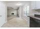 Open kitchen flows into a living room with a fireplace and a ceiling fan at 3732 Landgraf Cv, Decatur, GA 30034