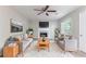 Inviting living room with cozy seating, fireplace, ceiling fan, and natural light at 3732 Landgraf Cv, Decatur, GA 30034