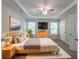 Serene main bedroom with tray ceiling, ceiling fan, natural light, and a cozy rug at 3732 Landgraf Cv, Decatur, GA 30034