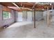 Unfinished basement featuring concrete flooring, exposed pipes, and natural light from the window at 4651 Palm Dr, Douglasville, GA 30135