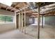 Unfinished basement featuring exposed beams, concrete floors, and natural light from a window at 4651 Palm Dr, Douglasville, GA 30135