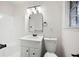 Bathroom featuring a white vanity, arched mirror, modern lighting, and white tiled shower at 4651 Palm Dr, Douglasville, GA 30135