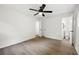 Bedroom showcasing hardwood floors, a ceiling fan, and a bathroom with white fixtures at 4651 Palm Dr, Douglasville, GA 30135