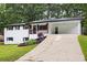 Charming home with white painted brick, a covered parking area, and a well-maintained lawn at 4651 Palm Dr, Douglasville, GA 30135