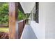 Spacious porch features dark wood accents, painted brick and is perfect for outdoor seating at 4651 Palm Dr, Douglasville, GA 30135