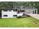 Charming single-Gathering home with a brick exterior, manicured front lawn, and covered carport at 4651 Palm Dr, Douglasville, GA 30135