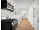 Updated kitchen features modern stainless steel appliances, white cabinetry and an exterior door at 4651 Palm Dr, Douglasville, GA 30135