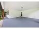 Covered patio with white brick walls and gray painted floor, perfect for outdoor relaxation at 4651 Palm Dr, Douglasville, GA 30135