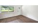 Bright room with wood-look floors, a window view to backyard, and access to porch at 4651 Palm Dr, Douglasville, GA 30135