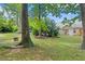 Secluded backyard featuring a cozy fire pit, lush lawn, and mature trees for shade and privacy at 1062 Sasha Ln, Roswell, GA 30075