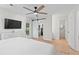 Bright bedroom featuring a ceiling fan, door to the outside, and walk-in closet at 1062 Sasha Ln, Roswell, GA 30075