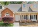 Charming townhome with brick accents, front porch and beautiful landscaping at 1062 Sasha Ln, Roswell, GA 30075