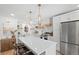 Bright kitchen featuring an island with a quartz countertop and stainless steel appliances at 1062 Sasha Ln, Roswell, GA 30075