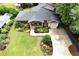 Aerial view of landscaped front yard, brick home and long driveway to attached garage at 236 Ridge Nw Ave, Marietta, GA 30064