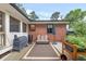 Cozy backyard patio with brick wall, outdoor furniture, grill, and tranquil water feature creating a relaxing space at 236 Ridge Nw Ave, Marietta, GA 30064