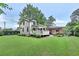 Beautiful backyard with a well-manicured lawn, deck, mature trees, and privacy fence at 236 Ridge Nw Ave, Marietta, GA 30064