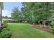 Expansive backyard featuring mature trees, lush lawn, storage shed, and outdoor gazebo at 236 Ridge Nw Ave, Marietta, GA 30064