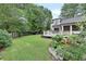Expansive backyard featuring a lush lawn, mature trees, patio, and garden creating a serene outdoor oasis at 236 Ridge Nw Ave, Marietta, GA 30064