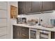 Stylish bar area featuring dark cabinetry, granite countertops, beverage cooler, and custom tile backsplash at 236 Ridge Nw Ave, Marietta, GA 30064