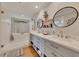 Well-lit bathroom featuring double sinks, modern fixtures, soaking tub, and glass-enclosed shower at 236 Ridge Nw Ave, Marietta, GA 30064