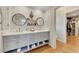Bathroom featuring double sinks, modern fixtures, shelving, and closet access at 236 Ridge Nw Ave, Marietta, GA 30064