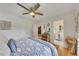 Comfortable bedroom featuring a ceiling fan, hardwood floors, and an ensuite bathroom with a white vanity at 236 Ridge Nw Ave, Marietta, GA 30064