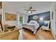 Charming bedroom with hardwood floors, a ceiling fan, a blue accent wall, and a window with bright, natural light at 236 Ridge Nw Ave, Marietta, GA 30064