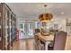Dining area featuring wood floors, modern light fixture, and glass doors to the outside at 236 Ridge Nw Ave, Marietta, GA 30064