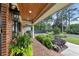 Welcoming brick porch with decorative planters and lush landscaping creates curb appeal at 236 Ridge Nw Ave, Marietta, GA 30064
