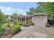 Lovely front yard with manicured landscaping, a brick home, and an attached garage at 236 Ridge Nw Ave, Marietta, GA 30064