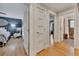 Hallway with hardwood floors connects the bedroom with the bathroom and features classic white trim and doors at 236 Ridge Nw Ave, Marietta, GA 30064