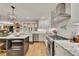 Bright, updated kitchen featuring stainless steel appliances and eat-in island, and open to other rooms at 236 Ridge Nw Ave, Marietta, GA 30064