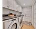 Bright laundry room featuring machines, sink, modern cabinets, and countertop space at 236 Ridge Nw Ave, Marietta, GA 30064