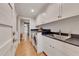 Modern laundry room with white cabinetry, dark countertop and sink at 236 Ridge Nw Ave, Marietta, GA 30064
