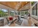 Bright sunroom with wooden ceiling, large windows, and comfortable seating for relaxing and enjoying natural light at 236 Ridge Nw Ave, Marietta, GA 30064