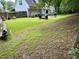 Wide backyard features lush green grass, mature trees, and an outdoor seating area at 25 Jessamine Trail Trl, Lawrenceville, GA 30046