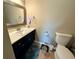 Bathroom featuring updated vanity with a granite counter top, a mirror, and toilet at 25 Jessamine Trail Trl, Lawrenceville, GA 30046