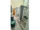 Bathroom with a glass enclosed shower, gray cabinets and trim, gray laminate flooring, and transom windows at 25 Jessamine Trail Trl, Lawrenceville, GA 30046