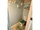 Powder room with sea shell decorations, sea-foam green rug and toilet seat cover, and beach-themed wall art at 25 Jessamine Trail Trl, Lawrenceville, GA 30046