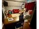 Bedroom with hardwood flooring, red leather couch, a desk, and a sports jersey on the wall at 25 Jessamine Trail Trl, Lawrenceville, GA 30046