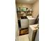Functional laundry room with modern appliances, wire shelves, and a bright, cheerful rug at 25 Jessamine Trail Trl, Lawrenceville, GA 30046