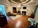 Large living room with a ceiling fan, fireplace, hardwood floors, and multiple seating areas at 25 Jessamine Trail Trl, Lawrenceville, GA 30046