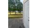 View of the backyard through a back door, highlighting the trees and neighboring home at 2735 Parkway Trl, Lithonia, GA 30058