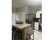 Bright kitchen with stainless steel appliances, a kitchen island with bar seating, and tile floors at 2735 Parkway Trl, Lithonia, GA 30058
