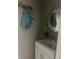 Stylish powder room featuring a decorative mirror, towel hooks, and modern vanity at 2735 Parkway Trl, Lithonia, GA 30058
