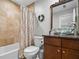 Bathroom showcasing a glass bowl sink, granite countertop, and tiled shower-tub combination at 3408 Lake Pointe Cir, Roswell, GA 30075