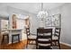 Bright dining area features hardwood floors, modern chandelier, and decorative painting at 3408 Lake Pointe Cir, Roswell, GA 30075