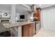 Eat-in kitchen featuring granite countertops, stainless appliances and brown cabinetry at 3408 Lake Pointe Cir, Roswell, GA 30075